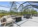 Screened lanai featuring a sectional sofa and dining area at 225 Sunset Point Dr, Ormond Beach, FL 32174