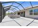 Large screened lanai with comfortable seating and outdoor kitchen at 225 Sunset Point Dr, Ormond Beach, FL 32174