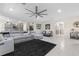 Open living room showcasing a sectional sofa, large area rug, and kitchen views at 225 Sunset Point Dr, Ormond Beach, FL 32174