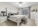 Spacious main bedroom with large bed, white dresser, and black accents at 225 Sunset Point Dr, Ormond Beach, FL 32174