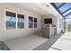 Outdoor kitchen with a built-in grill and a TV at 225 Sunset Point Dr, Ormond Beach, FL 32174