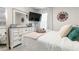 Bright bedroom featuring a white dresser and a comfortable bed at 225 Sunset Point Dr, Ormond Beach, FL 32174