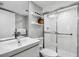 Clean bathroom with walk-in shower and floating shelves at 2615 S Atlantic Ave # 7H, Daytona Beach, FL 32118