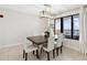 Elegant dining area with ocean view, modern light fixture, and seating for six at 2615 S Atlantic Ave # 7H, Daytona Beach, FL 32118