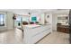 Open concept kitchen with island, ocean view, and white cabinetry at 2615 S Atlantic Ave # 7H, Daytona Beach, FL 32118