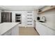 Modern white kitchen with stainless steel appliances and quartz countertops at 2615 S Atlantic Ave # 7H, Daytona Beach, FL 32118