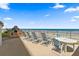 Beachfront patio with grill and seating area at 2615 S Atlantic Ave # 7H, Daytona Beach, FL 32118