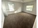 Spacious carpeted bedroom with two windows at 820 N Oleander Ave, Daytona Beach, FL 32118
