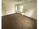 Carpeted bedroom with window and door to hallway at 820 N Oleander Ave, Daytona Beach, FL 32118