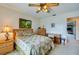 Cozy bedroom with a double bed, dresser, and desk, offering a view of another room at 2850 Ocean Shore Blvd # 15C, Ormond Beach, FL 32176