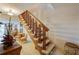 Wooden staircase with carpeted steps and wooden railing leading to the upper level at 2850 Ocean Shore Blvd # 15C, Ormond Beach, FL 32176