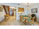 Bright dining area with wood table and chairs, offering a view of the kitchen and staircase at 2850 Ocean Shore Blvd # 15C, Ormond Beach, FL 32176