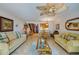 Spacious living room with yellow sofas, a coffee table, and views into the dining area at 2850 Ocean Shore Blvd # 15C, Ormond Beach, FL 32176
