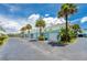 Row of garages with teal accents and palm trees at 2850 Ocean Shore Blvd # 15C, Ormond Beach, FL 32176
