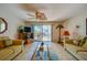 Relaxing living room featuring yellow sofas, a glass coffee table, and sliding doors to outdoor space at 2850 Ocean Shore Blvd # 15C, Ormond Beach, FL 32176