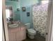 Bathroom with a shower/tub combo, vanity, and light blue walls at 1204 Casterton Cir, Davenport, FL 33897