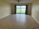 Spacious living room with tiled floors and sliding doors to water view at 35 S Ocean Palm Villas S Dr # 35, Flagler Beach, FL 32136