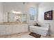 Elegant bathroom with soaking tub, double vanity, and large walk-in shower at 12245 Park Ave, Windermere, FL 34786