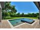 Inviting pool and spa with brick patio and lush landscaping at 12245 Park Ave, Windermere, FL 34786