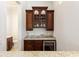 Built-in wet bar with granite countertop and wine cooler at 12245 Park Ave, Windermere, FL 34786