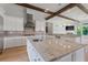 Bright kitchen with granite countertops, white cabinets, and a large island at 12245 Park Ave, Windermere, FL 34786