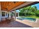 Covered patio with outdoor dining and pool view at 12245 Park Ave, Windermere, FL 34786