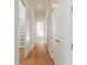 Long hallway with hardwood floors and access to closets and bathroom at 12245 Park Ave, Windermere, FL 34786