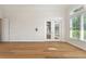 Spacious bedroom with hardwood floors and French doors leading to backyard at 12245 Park Ave, Windermere, FL 34786