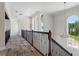 Elegant hallway with tile floors and wrought iron railing at 12245 Park Ave, Windermere, FL 34786