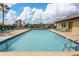 Community pool with lounge chairs at 3170 Ocean Shore Blvd # 305, Ormond Beach, FL 32176