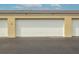White garage doors in a parking area at 3170 Ocean Shore Blvd # 305, Ormond Beach, FL 32176