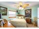 Bedroom with a queen-size bed, ceiling fan, and tropical artwork at 3170 Ocean Shore Blvd # 305, Ormond Beach, FL 32176