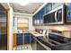 Cozy kitchen with blue cabinets, stainless steel appliances, and wood countertops at 3170 Ocean Shore Blvd # 305, Ormond Beach, FL 32176