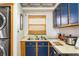 Efficient kitchen featuring blue cabinets and stainless steel appliances at 3170 Ocean Shore Blvd # 305, Ormond Beach, FL 32176