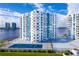 Aerial view of waterfront property with tennis court and two residential buildings at 935 N Halifax Ave # 907, Daytona Beach, FL 32118