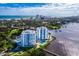 Aerial view of waterfront property with pool and nearby city skyline at 935 N Halifax Ave # 907, Daytona Beach, FL 32118