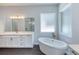 Bathroom boasts a freestanding tub and white cabinets at 260 Spreading Oak Ln, Ormond Beach, FL 32174