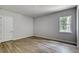 Simple bedroom with wood-look floors and a window at 260 Spreading Oak Ln, Ormond Beach, FL 32174