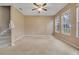 Living room with large windows, neutral carpet, and ceiling fan at 430 Ashley Brooke Ct # B, Apopka, FL 32712