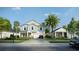 Two-story homes on tree-lined street with a car driving by at 1245 Champions Dr, Daytona Beach, FL 32124