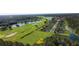 Aerial view of new homes near golf course and lake at 1245 Champions Dr, Daytona Beach, FL 32124