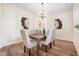 Formal dining room with wood table, chandelier, and neutral decor at 108 Oak Haven Cir, Deland, FL 32720