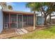View of the home's exterior, showcasing the screened porch at 10 Juniper Dr, Ormond Beach, FL 32176