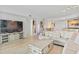 Bright living room with large sectional sofa, light wood floors, and city views at 231 Riverside Dr # 1904, Daytona Beach, FL 32117