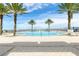 Relaxing community pool area with palm trees and waterfront views at 231 Riverside Dr # 1904, Daytona Beach, FL 32117