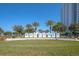 Welcoming entrance to the community with palm trees and signage at 231 Riverside Dr # 1904, Daytona Beach, FL 32117