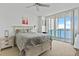 Bright bedroom with water views, king-size bed, and ample closet space at 231 Riverside Dr # 1904, Daytona Beach, FL 32117