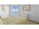 Bedroom with a green comforter, dresser, and water view at 231 Riverside Dr # 1904, Daytona Beach, FL 32117