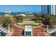 Aerial view of community entrance with welcome sign and landscaping at 231 Riverside Dr # 1904, Daytona Beach, FL 32117