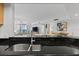 Modern kitchen sink and countertop with view to living room at 231 Riverside Dr # 1904, Daytona Beach, FL 32117